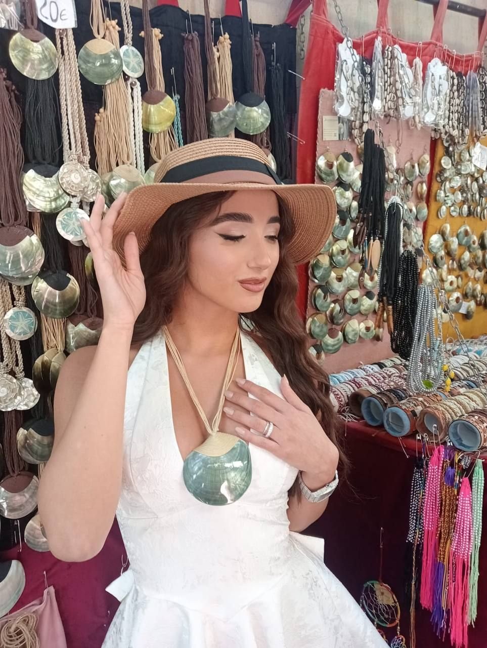 Donna con cappello di paglia e collana in madreperla